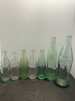 7 vintage Coca Cola glass bottles embossed green clear mixed sizes lot