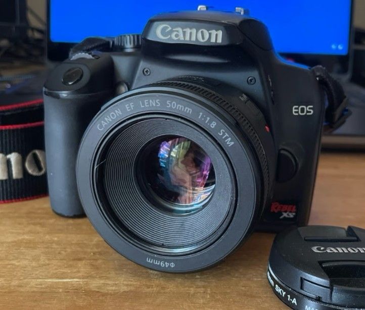 Canon EOS Rebel XS digital camera, 50mm f:1.8 ES STM lens, 2 batteries, charger
