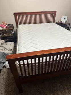 Wooden full size bed frame with mattress