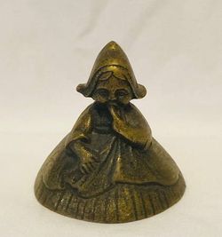Vintage Peerage England brass bell Dutch girl in dress bonnet with wings 2” tall