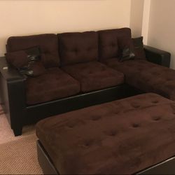 brown microfiber Sectional Sofa with Ottoman and 2 accent pillows.