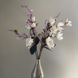 Silver vase and flower arrangement