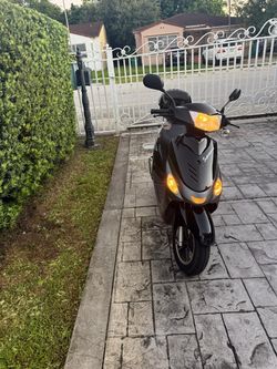 Black Motor Scooter with Running Lights