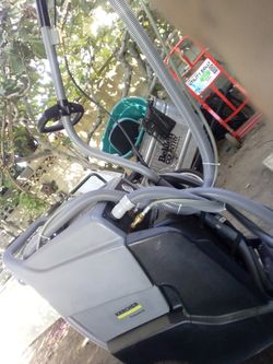 commercial portable carpet extractor, resembling the Kärcher Puzzi 50/14 E or Puzzi 64/35 E series.