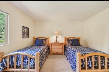 Two twin log pole bed frames