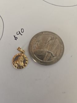 This dainty yellow gold religious medal is a timeless gift for a baptism, first communion, or confirmation. It features a beautifully embossed religio
