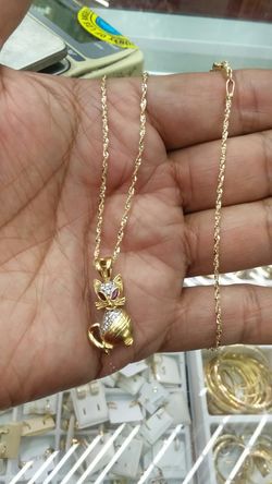 14k Gold chain 18 inch long 2.2 grams $120 14K charm 3 grams $150 cz stones high quality & rubys