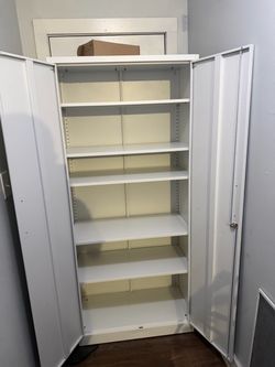 Tall Metal Storage Cabinet with Shelves, sofa, and coffee table with stools