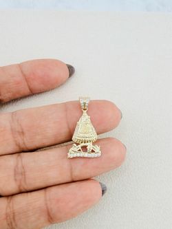 10K Gold Virgin of Charity Pendant 	•	Authentic 10K yellow gold pendant 	•	Accented with white cubic zirconia stones 	•	Virgin of Charity measures app