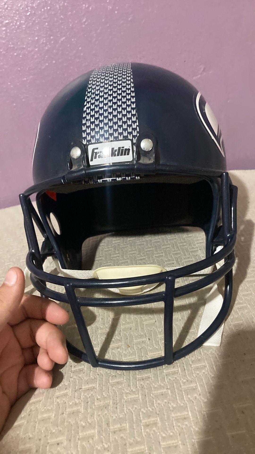 I don’t know what team it is, but yeah, football helmet not meant for real football just a prop