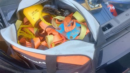 Duffel bag full of various ratchet straps and  metal anchors ect
