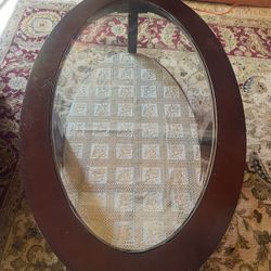 Brown wooden and glass oval coffee table