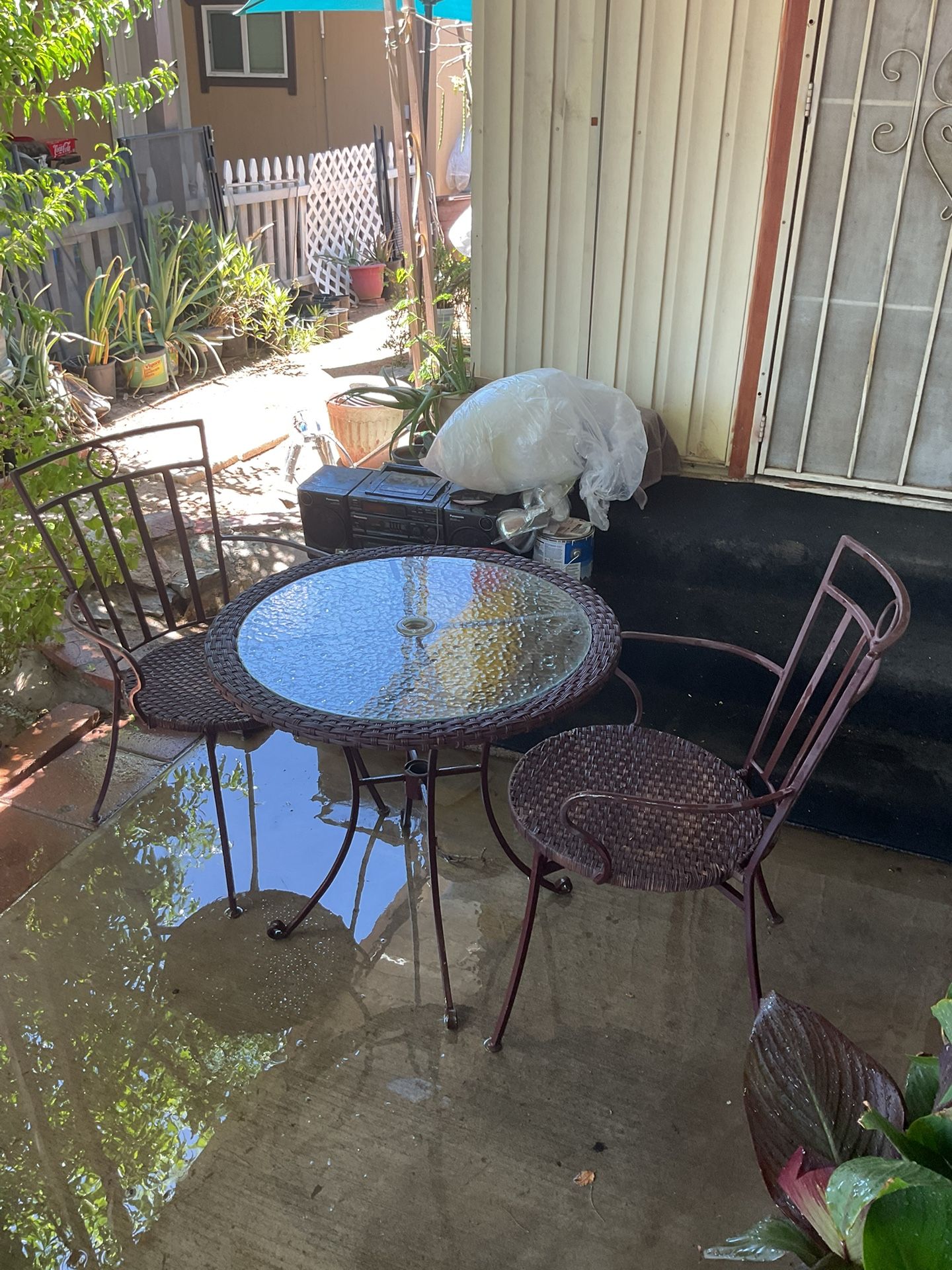 Glass Table With Two Metal Chairs