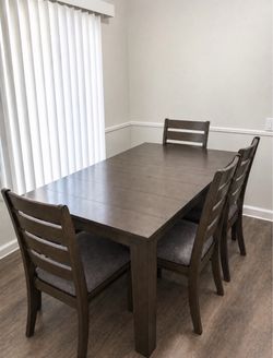 Gray wood table can fit between 8-10 persons