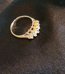 14 k with 5 diamonds. Ring is size 7