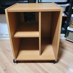 multi-purpose rolling table or storage cabinet, often used as a mobile office desk , TV stand, or kitchen mini-appliance station.