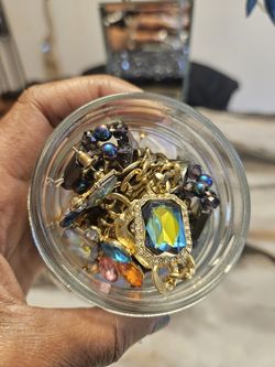 Jar of jewelry with iridescent jewelry