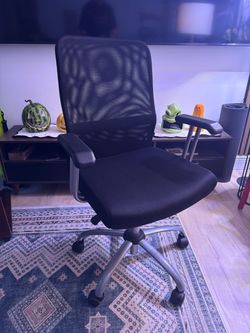 Ergonomic black mesh office task chair with a padded seat and a silver-finish base