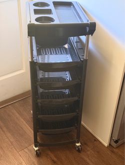 Black rolling salon trolley with storage trays