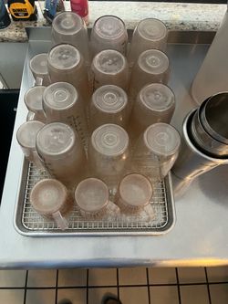 Tray of clean but used measuring cups