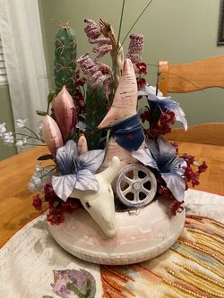 Vintage southwest faux cacti, flowers, coyote and skull in clay adobe house planter pot. Centerpiece