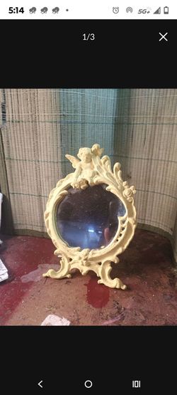 Vintage ornate tabletop mirror. Cherub accent Rococo style
