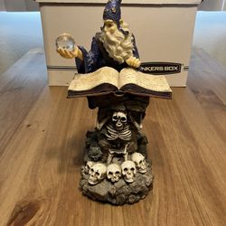 Merlin Statue With Skulls