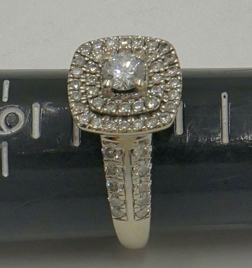 10kt white gold engagement ring 5 grams ,size 8, with main round diamond 0.30pts; 60 small round diamonds 0.70pts . 1 carat total approximately. 86241