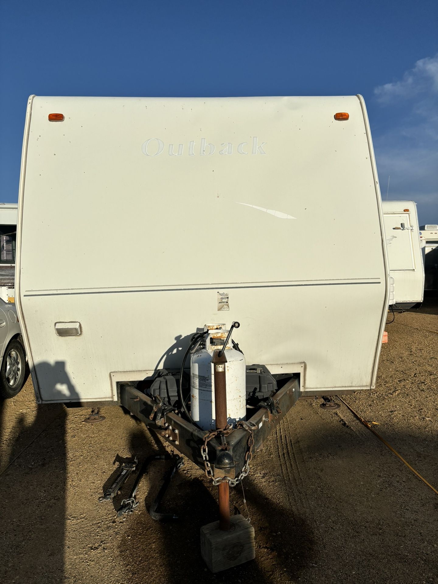2004 Keystone Outback 26RS bunk house a rear slide queen bed, a quad bunkhouse, and a dinette and couch that fold down, there is plenty of sleeping r