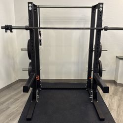 Rogue Monster Lite flat foot rack with bar and plates