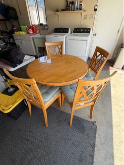 round wooden table with glass 4 chairs