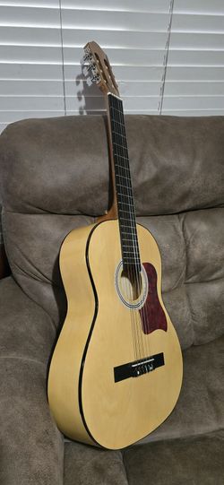 Nice acoustic guitar. Pacific G-44 ST model. Guitar has natural wood finish and black fretboard. Pickguard is red tortoise shell pattern. All strings 