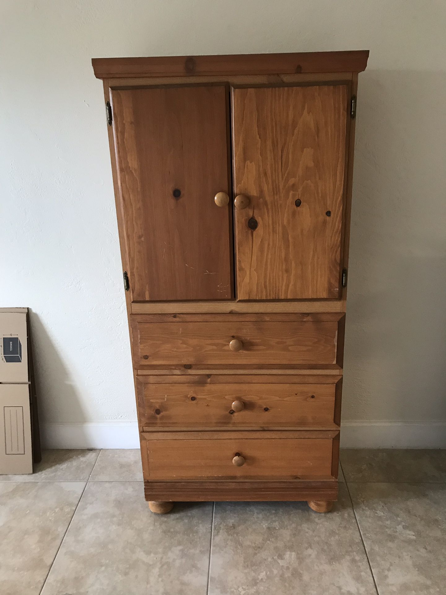 Tall light wood dresser with two shelves & three drawers.