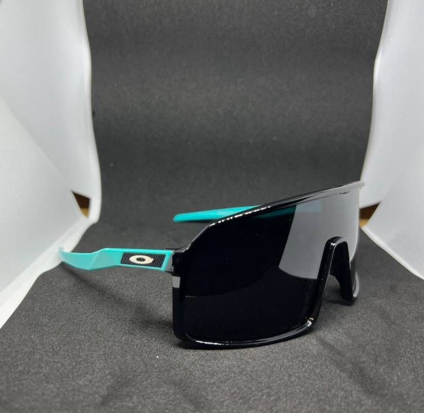 Oakley Sutro Sunglasses Black Frame W/ Prizm Polarized Lens & Cyan Arms