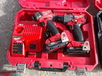 Milwaukee fuel impact driver and hammer drill set with battery charger and case
