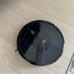 Title: Sleek Black Robotic Vacuum Cleaner with Dock and Remote 
