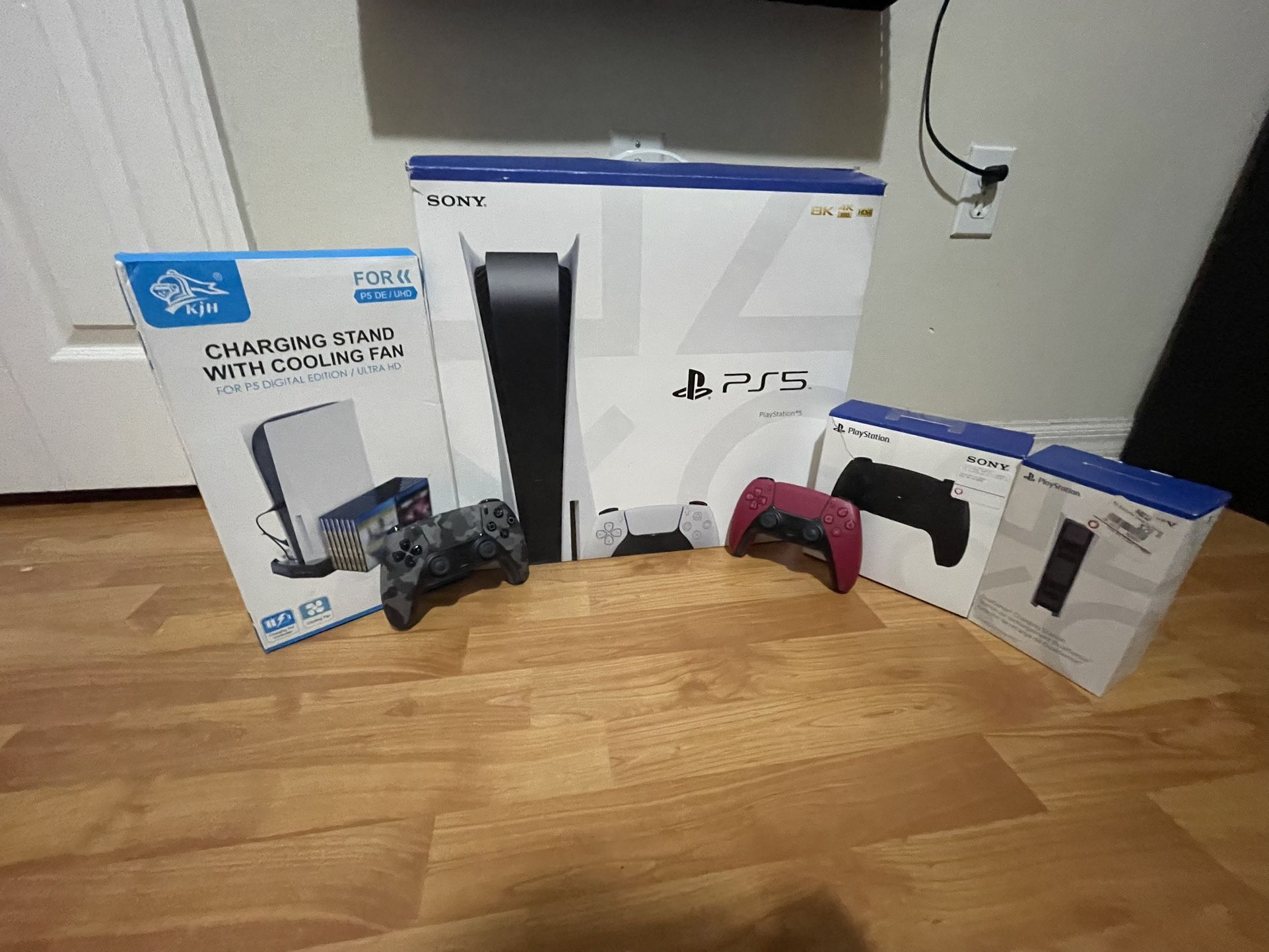 PS5 With 3 Controllers (not Including The One In The Box) A Charging Stand With A Cooling Fan And A Charging Stand