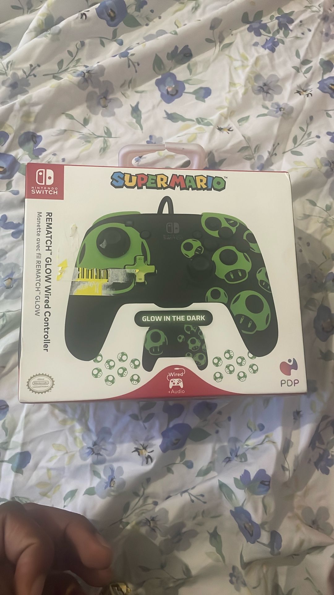 PDP REMATCH GLOW Wireless Controller for Nintendo Switch with a Super Mario-themed design featuring 1-Up Mushrooms