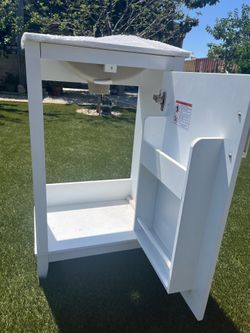 White single door bathroom vanity with sink