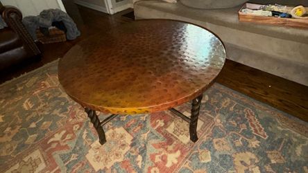 36 “ x 20 “ - hammered copper table. Neiman Marcus. Wrought iron legs.
