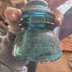 vintage aqua blue glass electrical insulator, specifically a Hemingray-42 model. 
It was produced by the Hemingray Glass Company, an American glass ma