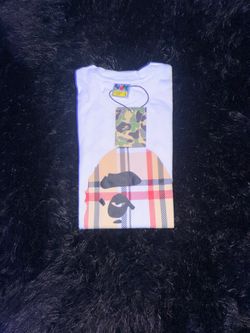 BAPE white tee with black ape head graphic on beige and red plaid background, size L