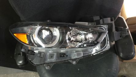 18 Mazda 3 Rt headlight.