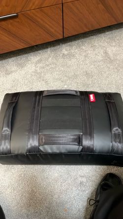 Black Combat Corner (CRNR) gear bag featuring heavy-duty nylon webbing straps and a red logo tag.