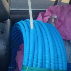 The blue item in the image is a roll of corrugated tubing, likely used as an electrical conduit or a plumbing/drainage pipe. 