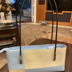 Shoulder bag in heavy vinyl material with two straps attached with silver like buckles outside zipper enclosure inside zipper pocket very good
