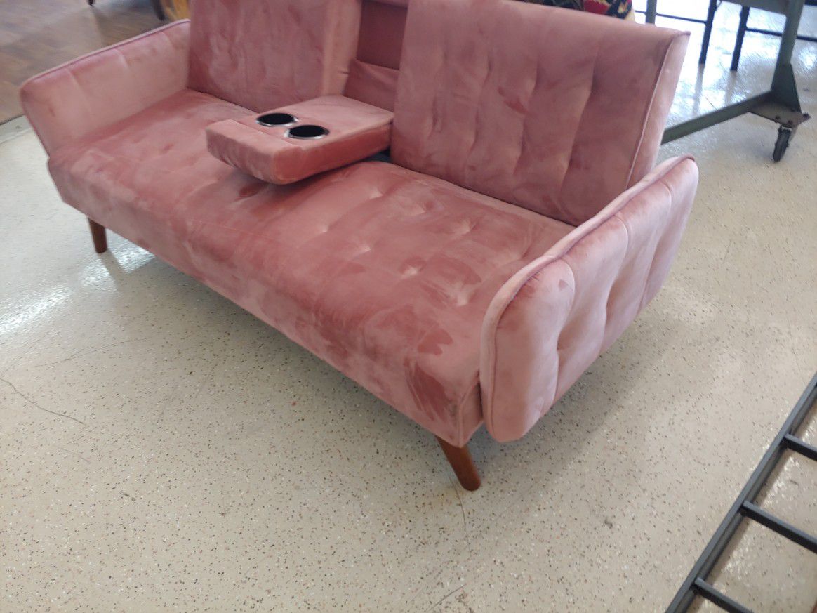Pink velvet futon sofa with fold-out cup holders $324.99