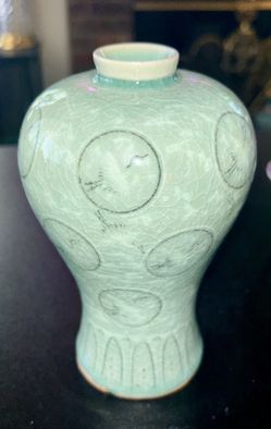 Korean celadon vase featuring a signature jade green glaze and an inlaid crane and cloud moti