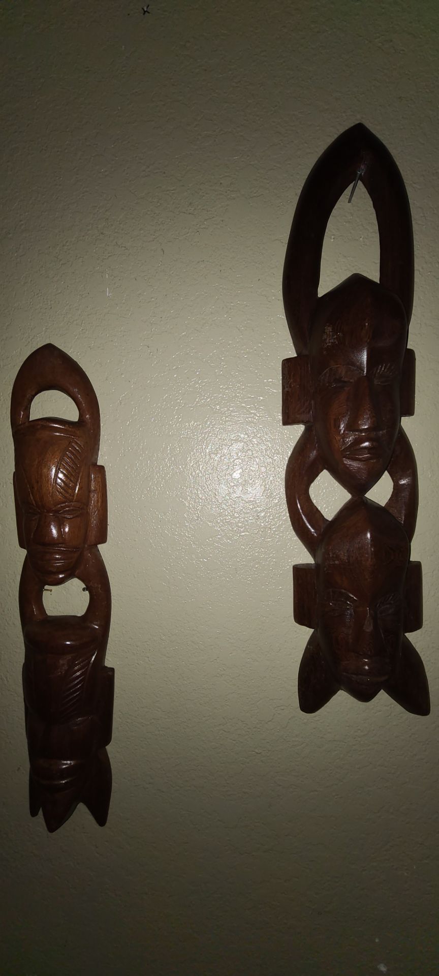 Vintage handcrafted African-style wooden wall sculptures.