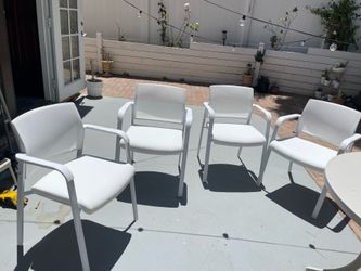 4 Brand New Stacking white leather chairs